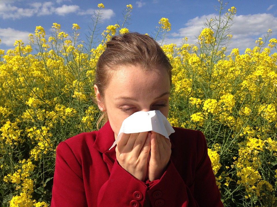 Woman covering her nose with a tissue